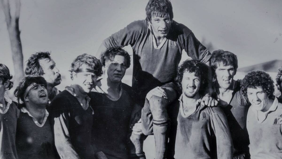 Champs: Reg Smith being carried off after 1981 Grand Final . L. Anderson, M. Bullock, R. Rolff, M. Cummins, D. Taylor, R. Smith, K. Montgomery, B. Williams, R. Gulliver.