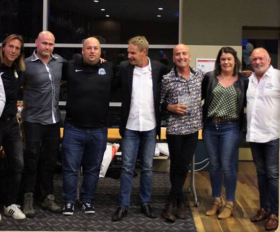 The Rainbow Warriors team receive the club of the year trophy at the Football Mid North Coast presentation. FMNC chairman Mike Parsons is pictured on the right.
