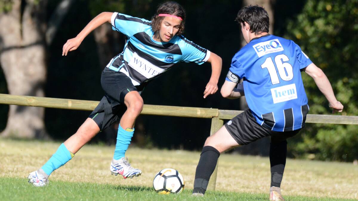 Taree's Zac Robson tries to beat a Port Saints opponent in the Coastal Premier League southern conference match at Taree. Port won 5-0.