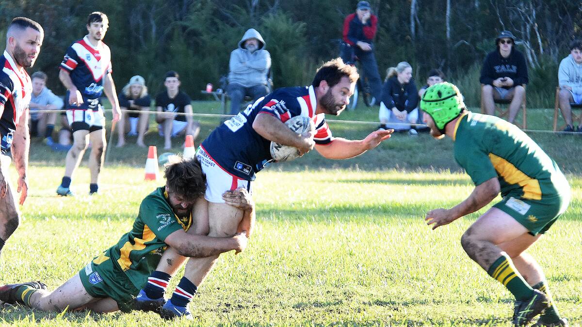 Old Bar's Jonathon Tickle is tackled by Forster-Tuncurry defenders during the Group Three game at Old Bar. Tickle was a try scorer in the Pirates' 32-12 win.
