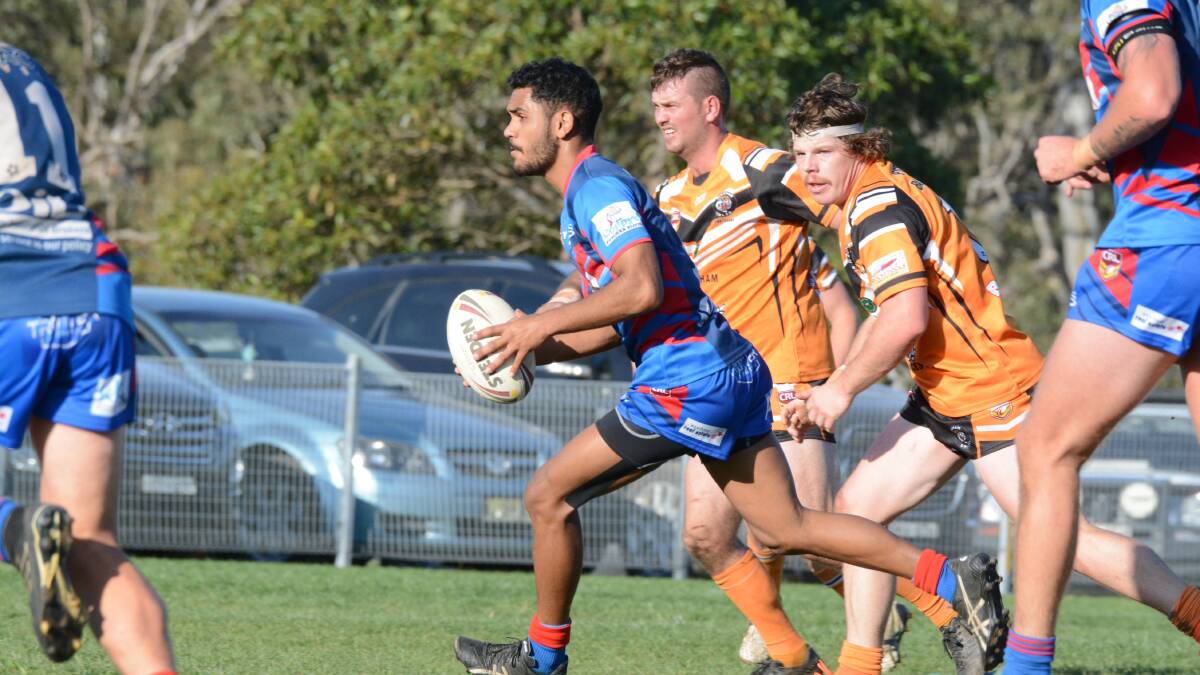 Clever Wauchope halfback Tristan Scott races through a gap in the Wingham defence during the preliminary semi-final won 28-14 by the Blues. Photo Scott Calvin.