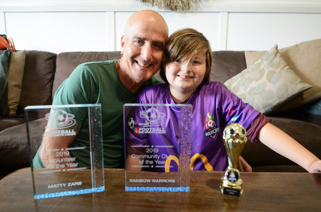 Matty Zarb and his son Marli and the trophies won at the Football Mid North Coast presentation.