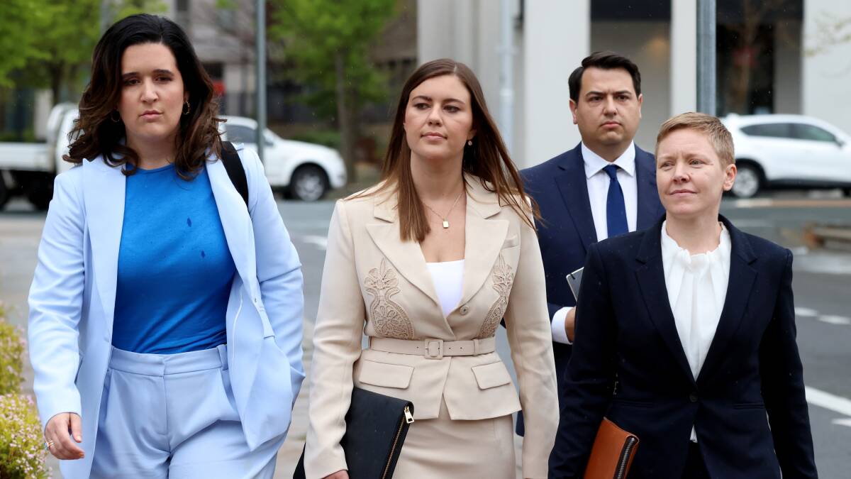 Brittany Higgins, centre, arrives at court to give evidence during Bruce Lehrmann's trial. Picture by James Croucher