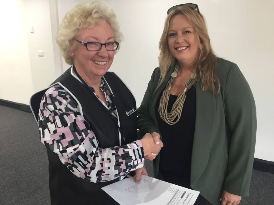 It's yours: Returning officer Maureen Morris officially confirming Peta Pinson our new mayor.