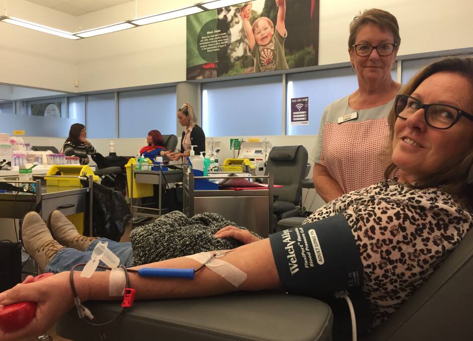 Special day: Learne Lincoln giving her 25th blood donation as staff member Louise Harris looks on.