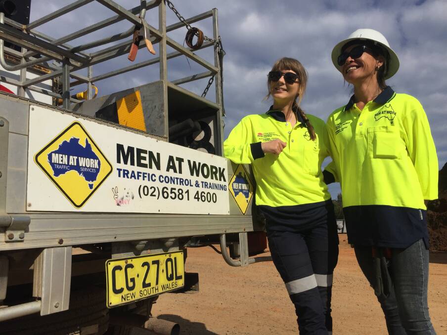 Smile on your dial: Men At Work's Tegan Wiseman and Krystal Tahitahi say making people smile while waiting at road works is part of their job description.