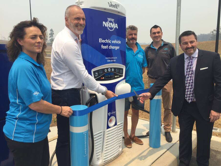 Charging station: Breakwall Caravan Park operator Dawn and Ray Marchmant (third from left), Lewis Land Group CEO Chris Calvert, NRMA Road Service proprietor Brett Robinson and Cowper MP Pat Conaghan.