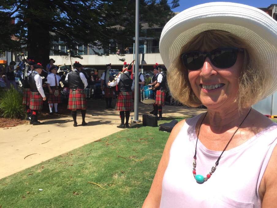 Love the sound: Scotland's Ann Bates soaking up the atmosphere on Town Green as part of International Bagpipes Day on Sunday.