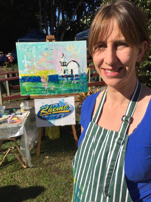 Gone in 360 seconds: International speed painter Jennifer Cooper with her completed artwork of Port Macquarie's lighthouse.