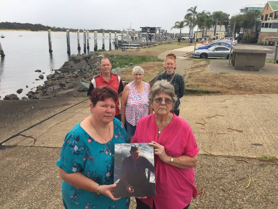 In his honour: Cecil Hyde's daughter Kerrie-Anne Charry and wife Pam holding a photo of the commercial fishing leader with son Wayne, long time family friend Judy Stace and granddaughter Katie Hyde.