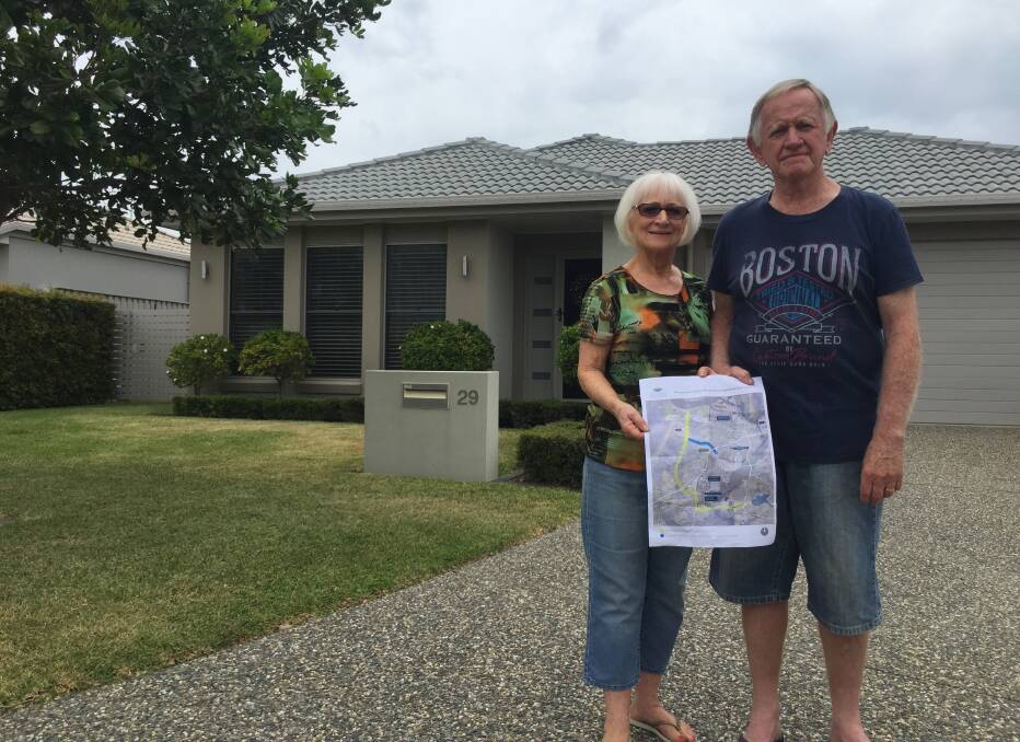 Our castle: Dorothy and Neil Morgan outside their Sanctuary Springs home that is in the centre of the orbital road investigation corridor. Mrs Morgan is holding a plan for the road that would run right through their home.