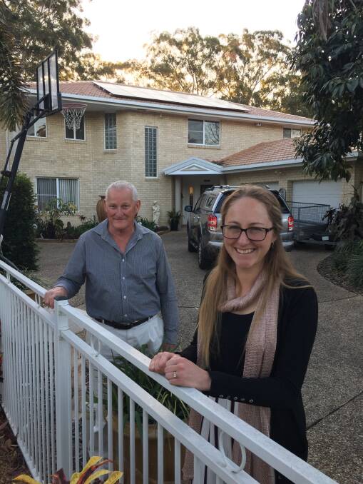 Up on the roof: Jim Gardner and daughter Aimee with their new solar installation. 