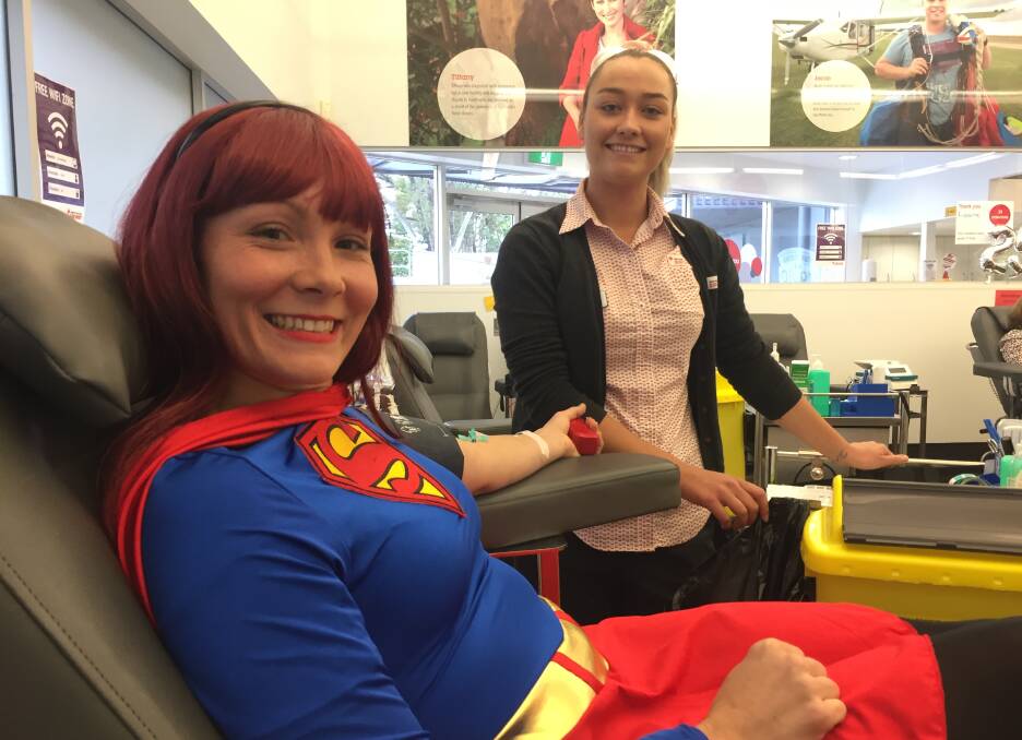 Super effort: Superwoman Nicky Thompson giving blood as Bianca Wright helps out.