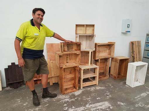 Ready to go: Trainer Mark Dalton with some of the timber crates students have been constructing to sell at the garage sale on November 18. Photo: supplied