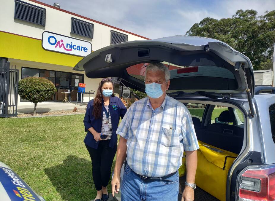 New home: Omnicare senior branch officer Tamara King helping volunteer Peter Koop load up his vehicle for a delivery run. Photo: supplied