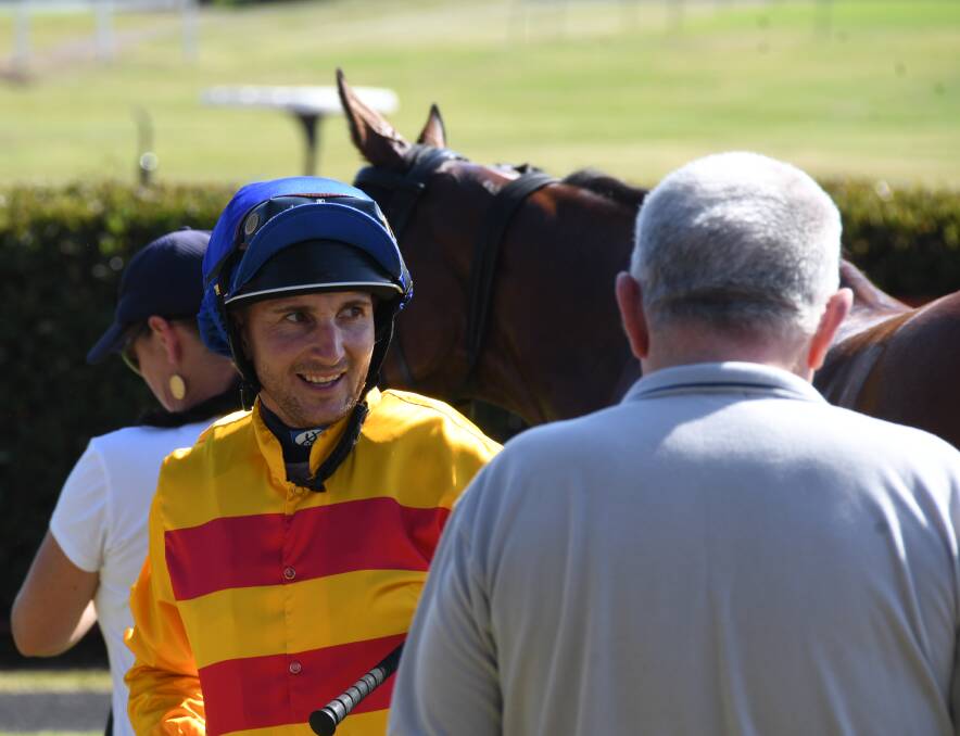 Success: Giddyup's jockey Luke Rolls following his ride in the New Year's Day Cup at the Port Macquarie Race Club's meeting on Tuesday.