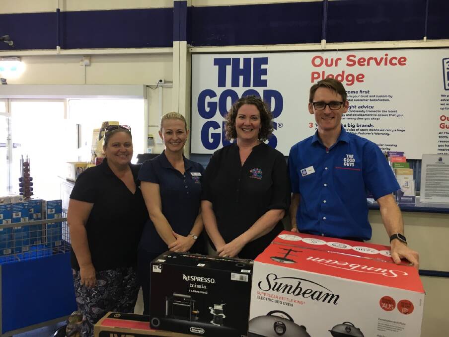 Helping hand: Christmas raffle prizes: Early Connections administrator Bronwyn Woods, BabyToddler Playgroup co-ordinator Katie Freeman and service manager Beth Todd say thank-you to The Good Guys Port Macquarie manager, Tony Green.