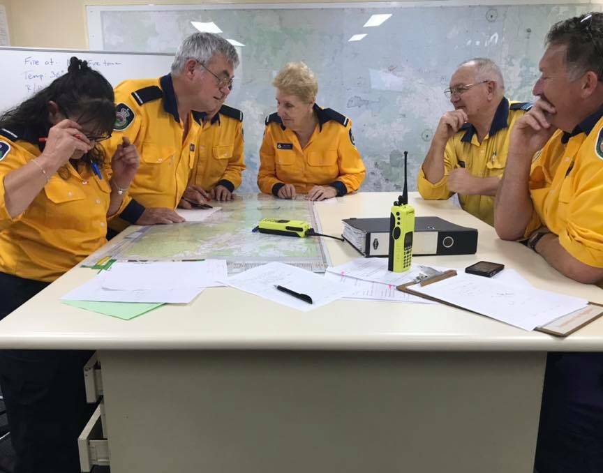 Planning continue: NSW Rural Fire Service team members discussing the current bushfire threat to the Port Macquarie-Hastings.
