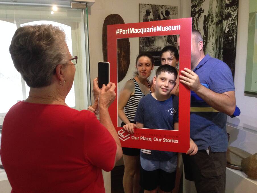 Snap: Lil Andrews helps out with a photo during Museum Selfie Day.
