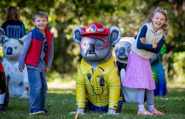 Koala festival: Josh and Jemma practice their social pics for the Festival Treasure Hunt with Frankie Firefighter. Photo: Lindsay Moller Productions