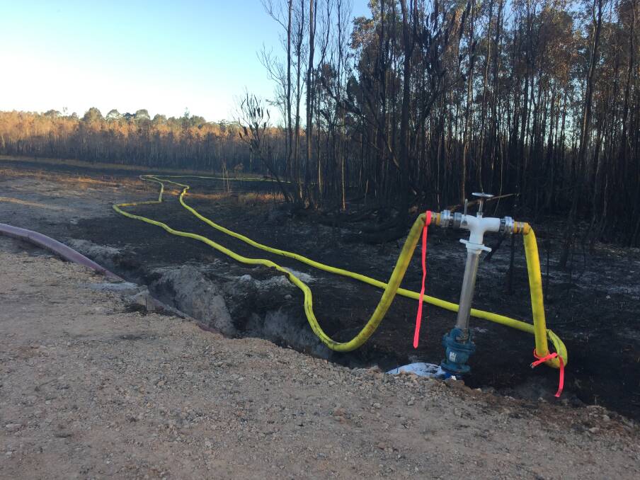 Ready to flow: Port Macquarie-Hastings Council staff completed the 2400 metre pipeline to the Lindfield Park Road bushfire site on Monday afternoon.