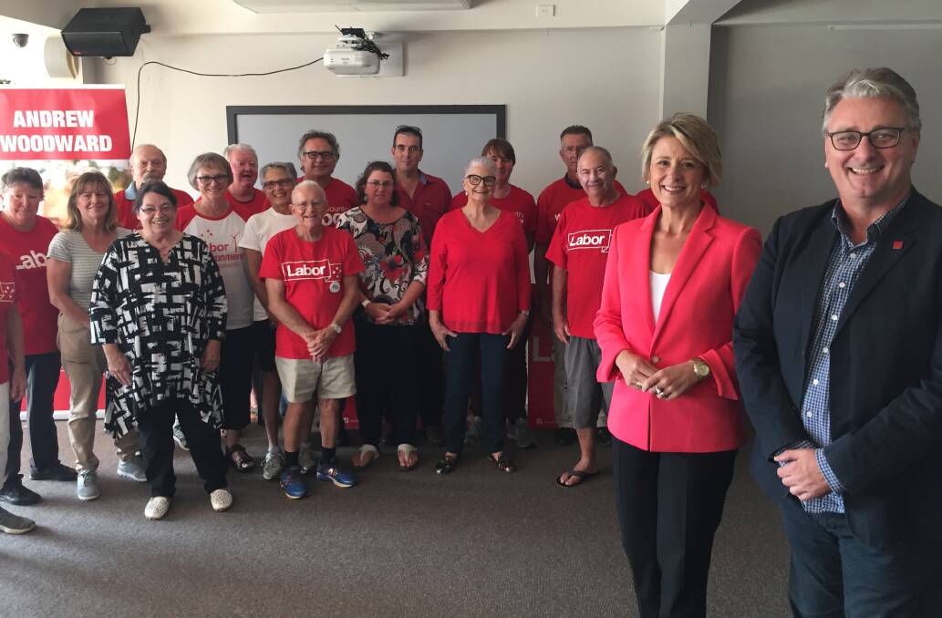 On the bus: Senator Kristina Keneally and Labor candidate for Cowper Andrew Woodward with supporters in Port Macquarie on Thursday, April 11.