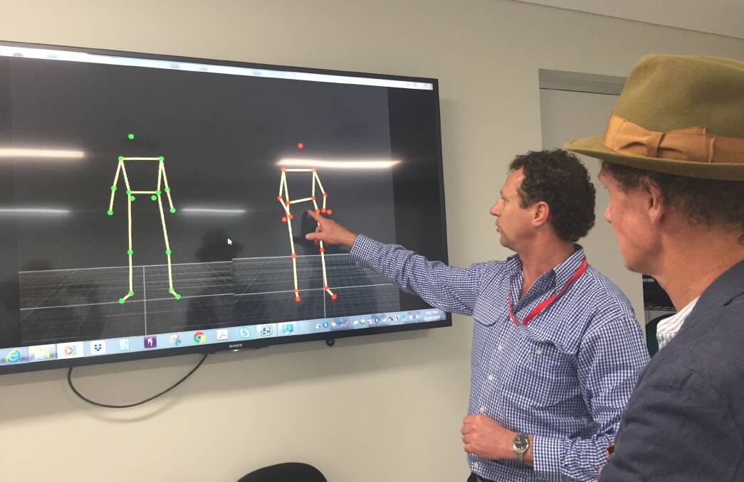 Hi-tec: CSU project officer on the refurbished Munster Street facility Neal Molineaux showing Matt Ryan the results from the 3D motion capture system.