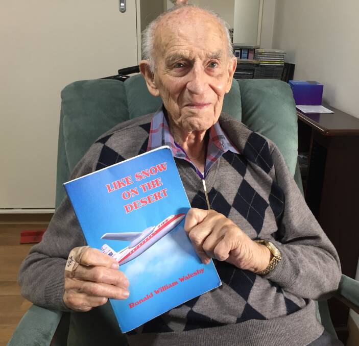 60 years on: Port Macquarie's Ron Walesby, who is celebrating 60 years with Rotary, with  his book Like Snow On The Desert which details his war and flying experiences.