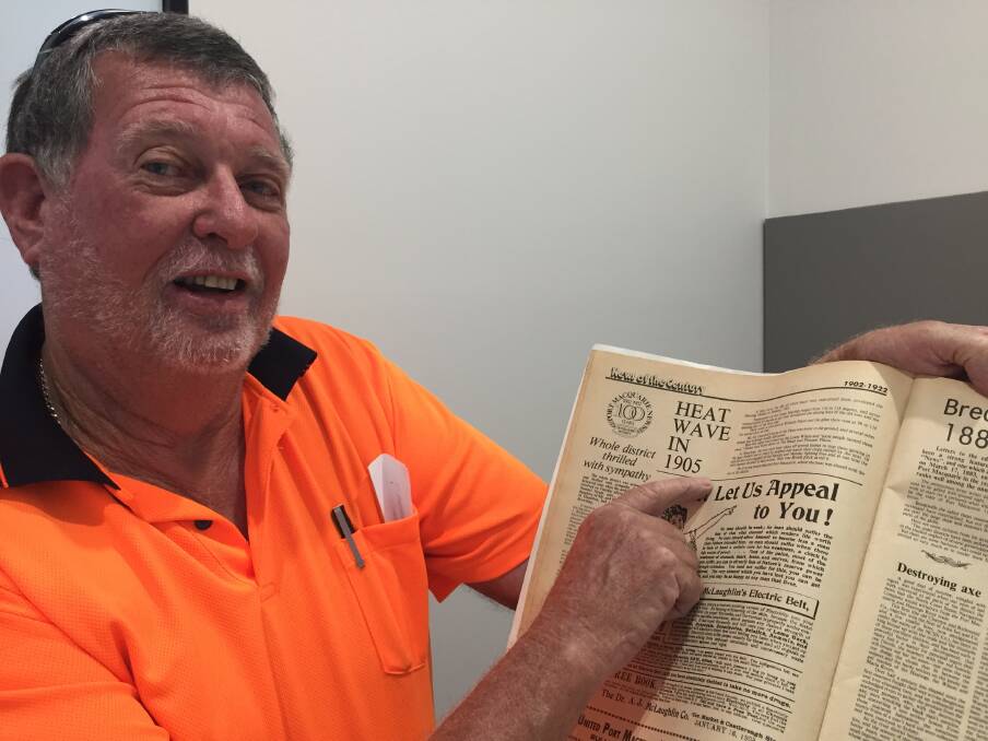 Hot topic: Port Macquarie's Bob McQuaid pointing to the 1905 story about heatwave conditions.