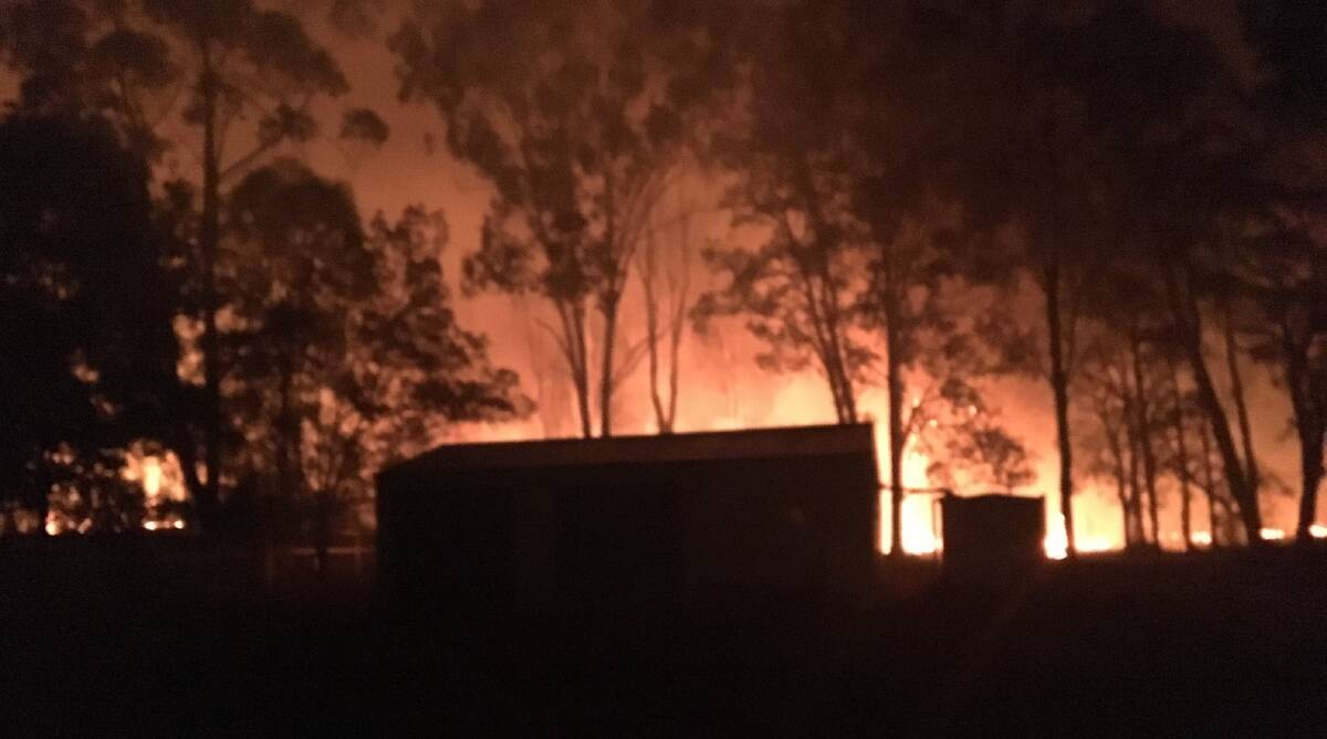On fire: The quick and dedicated response from RFS crews and other agencies was responsible in having no lost homes from the Crestwood/Lake Cathie bushfire. Photo: Glen Dale