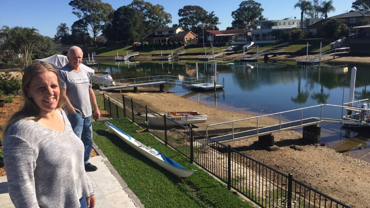 Come on council: Ballina Crescent residents Deborah Hale and Mike Cooper overlooking the canals at the rear of their respective homes.