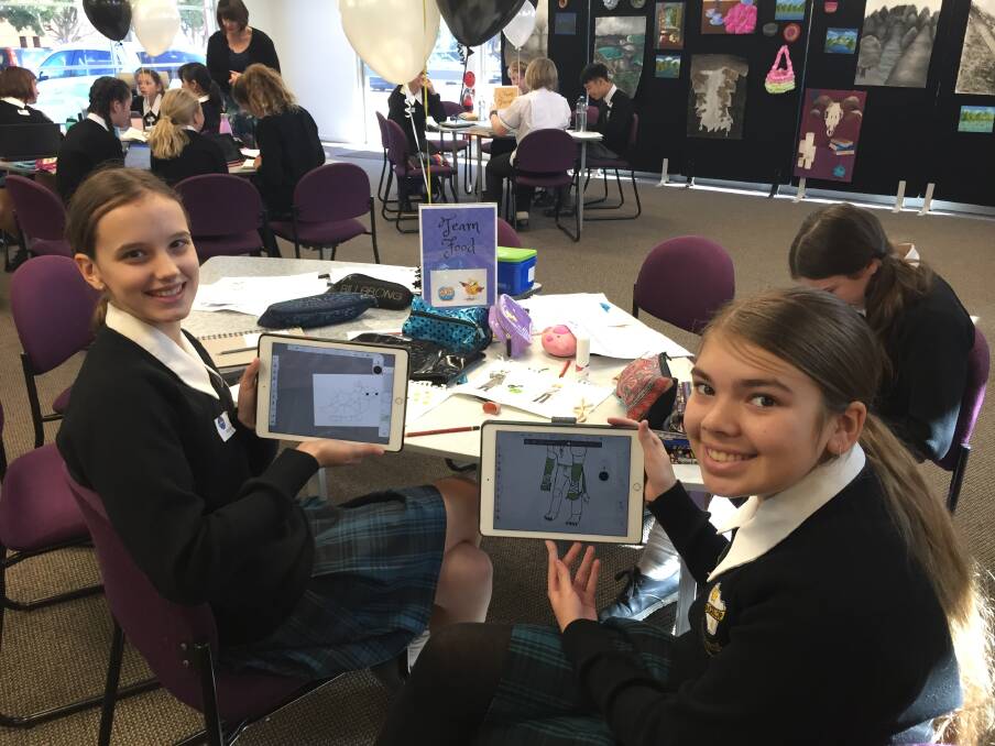 Book design: MacKillop College year 8 students Matilda Fel and Kyla Patterson with some of their illustrations for their write a book in a day. 