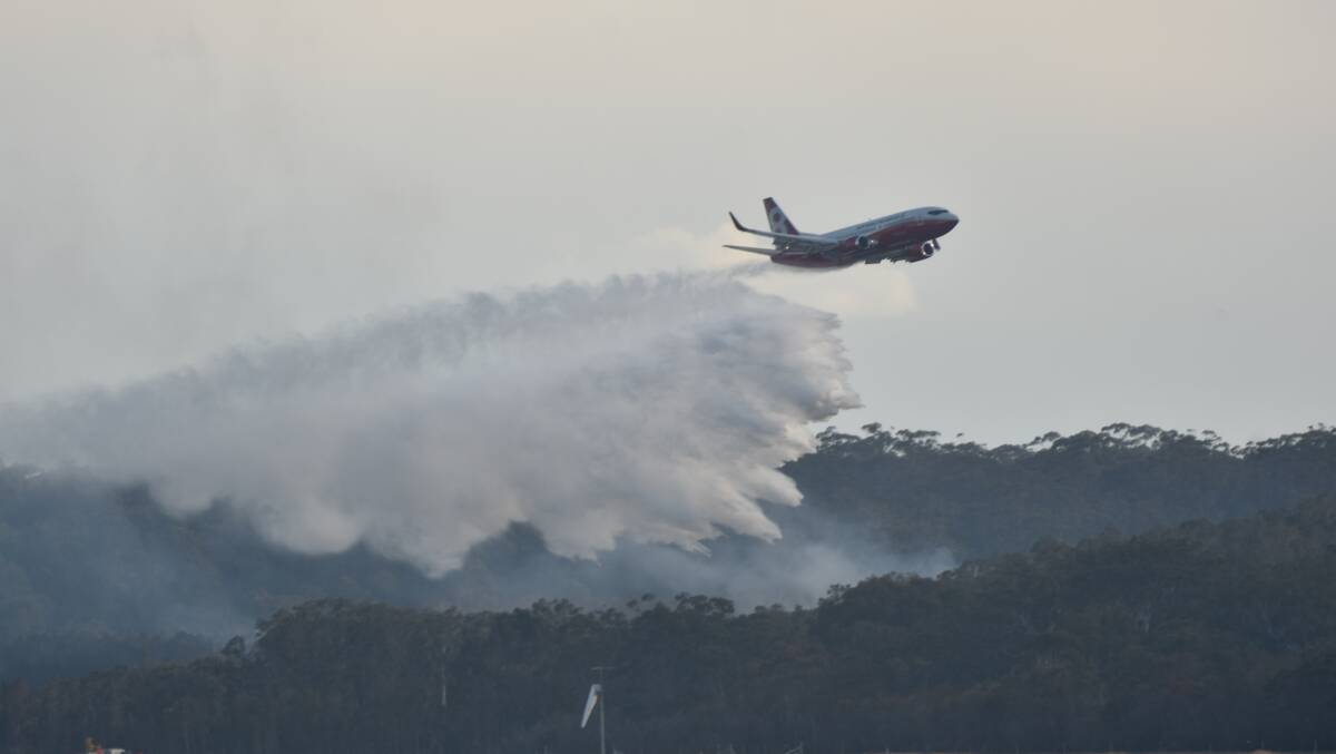 Water bombed: The 737 large air tanker Marie Bashir makes her maiden water drop on the Lindfield Park Road bushfire in August, 2019. Photo: Rob Dougherty.