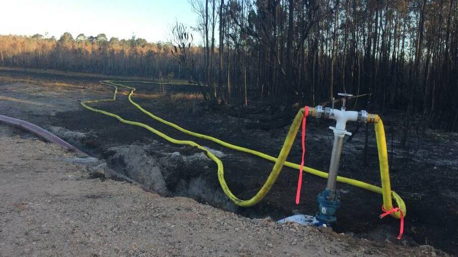Rehydration: Reclaimed water piping leading to the Lindfield Park Road fire. Photo: Peter Daniels.