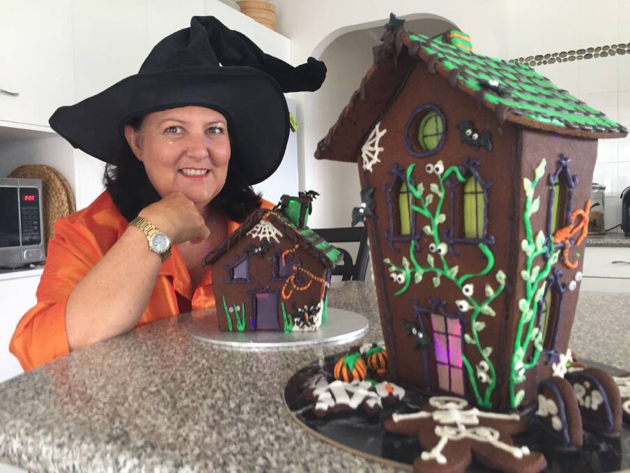 Spooky house: North Shore's Carla McKern with her two home-made gingerbread houses that will be part of Halloween activities on Kangaroo Park (adjacent to the north side landing of Settlement Point ferry) on Wednesday October 31.