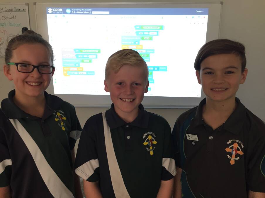 Code crackers: St Joseph's Primary School students Milly McGrath, Dexter Maher and Cooper Winn are, officially, tops in code cracking.