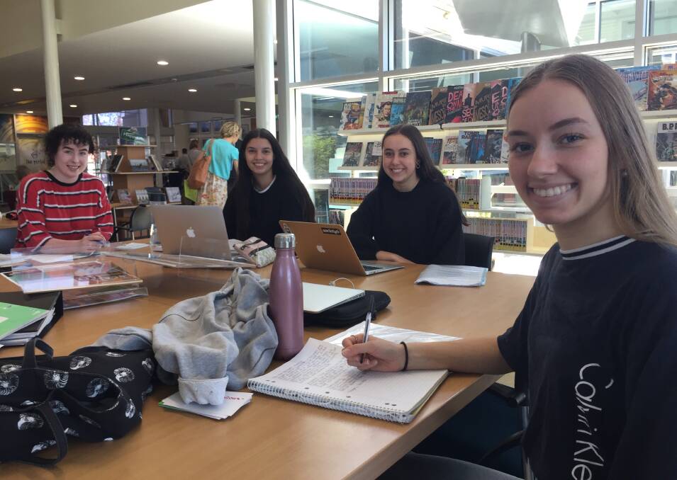 Ready to go: MacKillop College Port Macquarie year 12 students Olivia Bendall, Kelsey Partridge, Ruby Derrick and Phoebe Blundell bunkered down in the Port Macquarie Library on Tuesday.