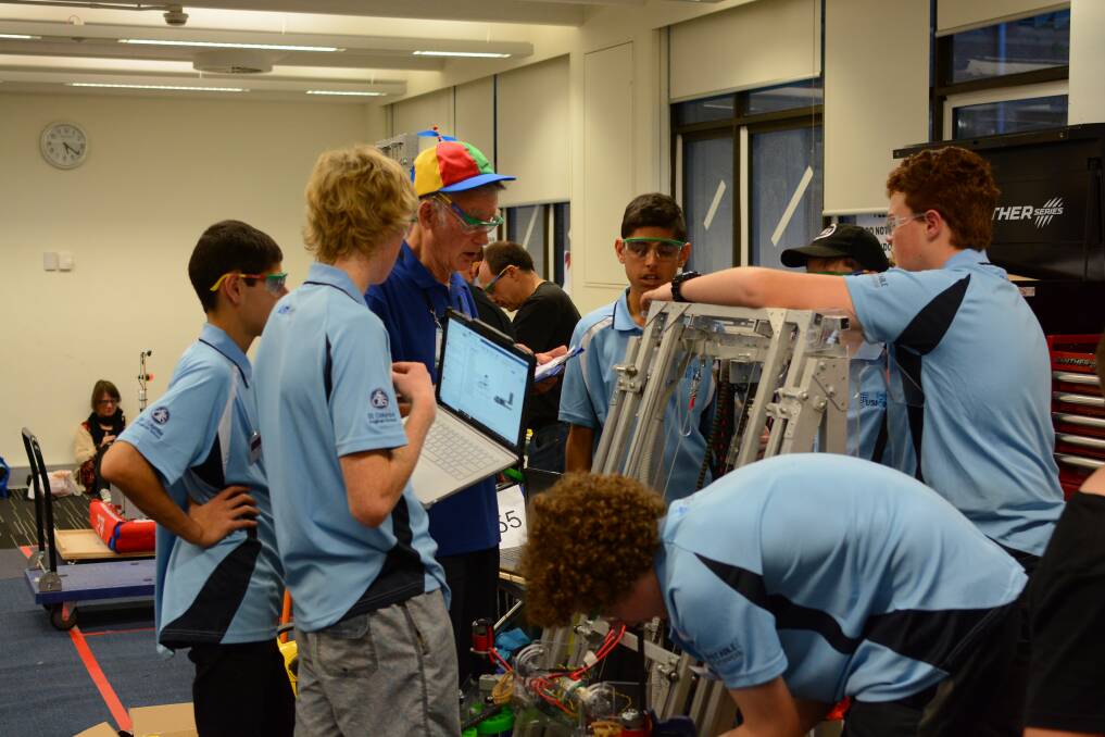 Working hard: St Columba Anglican School students participating in the robotics competition. Photo: supplied