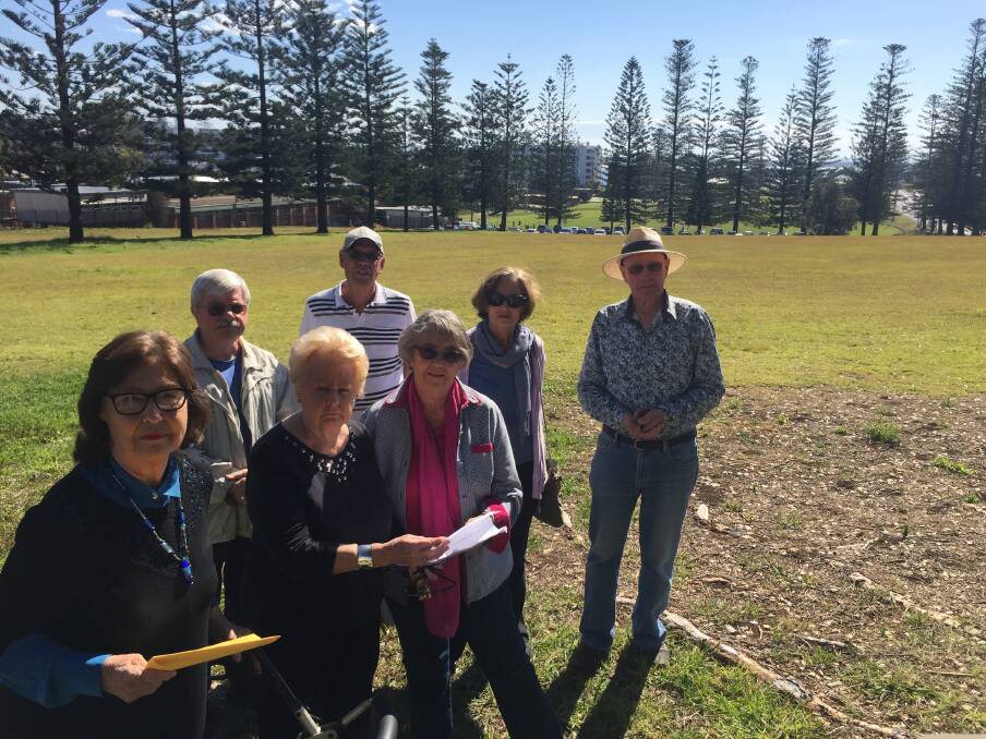Mystified: Burrawan Street residents Margaret Buckman, Jenelle Francis and Dawn Mallinson and Jeff Austin, Rod Mallinson, Chris Coorey and David Brown believe siting the new aquatic centre on open green space opposite their homes is wrong.
