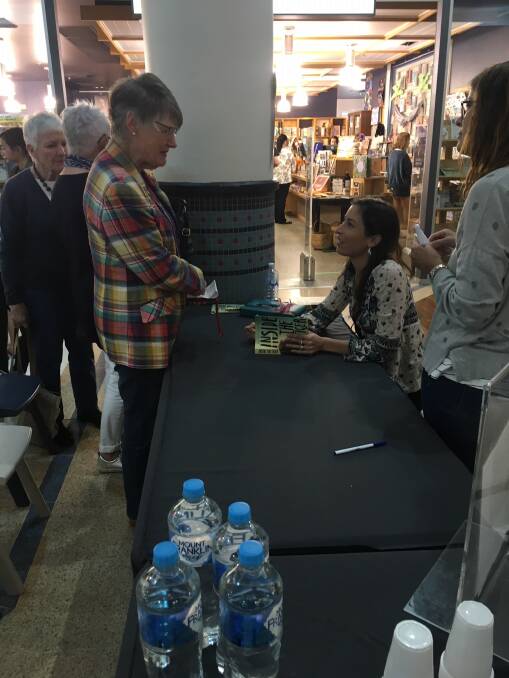 The launch: Port Macquarie author Hayley Lawrence, seated, signing books during the launch of Inside The Tiger on Saturday. Photo: supplied
