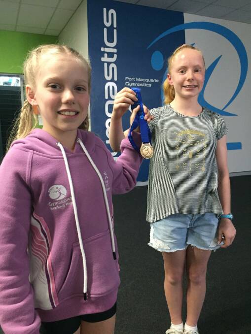 That's gold: Clair Wilcox and Harmony Mitchell have returned from the State Gymnastics Championships with respective gold medals.