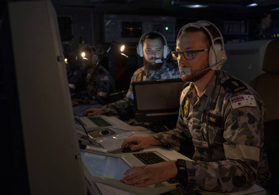 Cybersecurity: Combat systems operator Michael Curry monitors his console onboard HMAS Toowoomba. Picture: Department of Defence 
