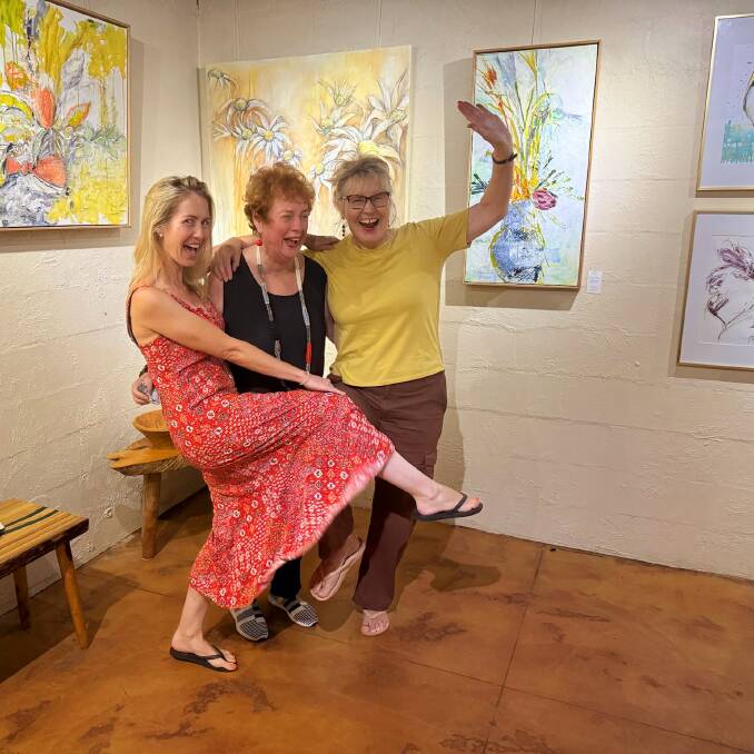 Jane Whitfield, Alita Allison and Yvonne Kiely, whoop it up after hanging their joint works. Picture supplied.