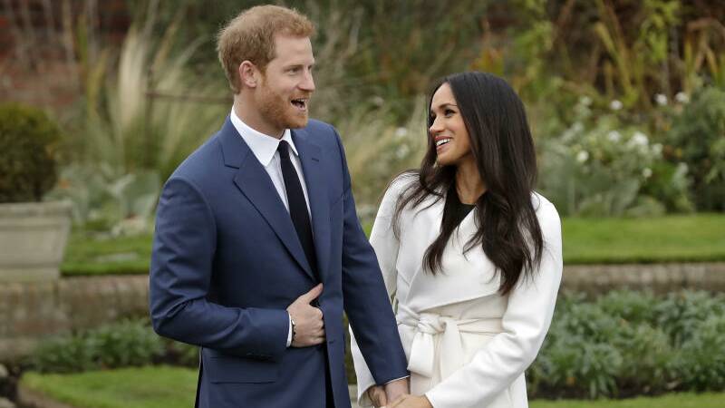  Monday Nov. 27, 2017, Britain's Prince Harry and fiancee Meghan Markle pose for photographers during a photocall in the grounds of Kensington Palace in London, marking the couple's engagement to marry.