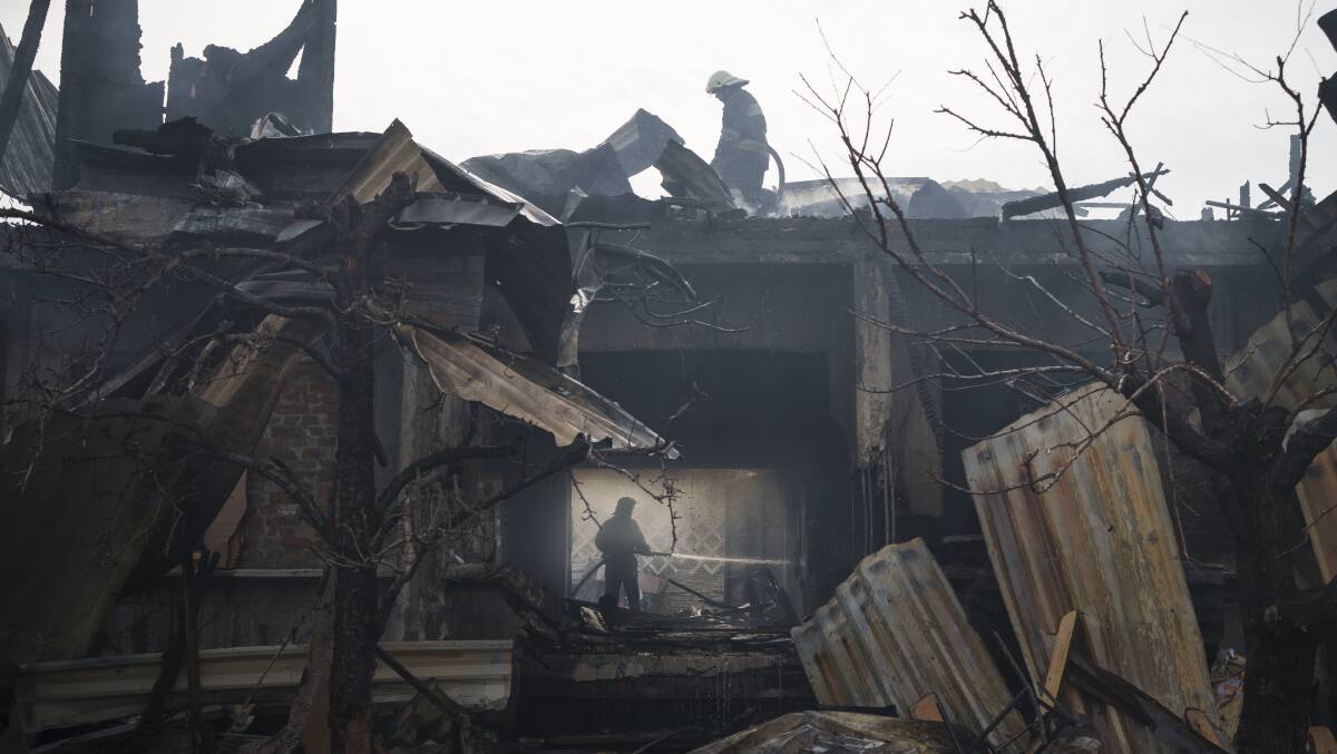 Firefighters work to extinguish a fire at a house after a Russian attack in Kharkiv on Monday. Picture: AAP