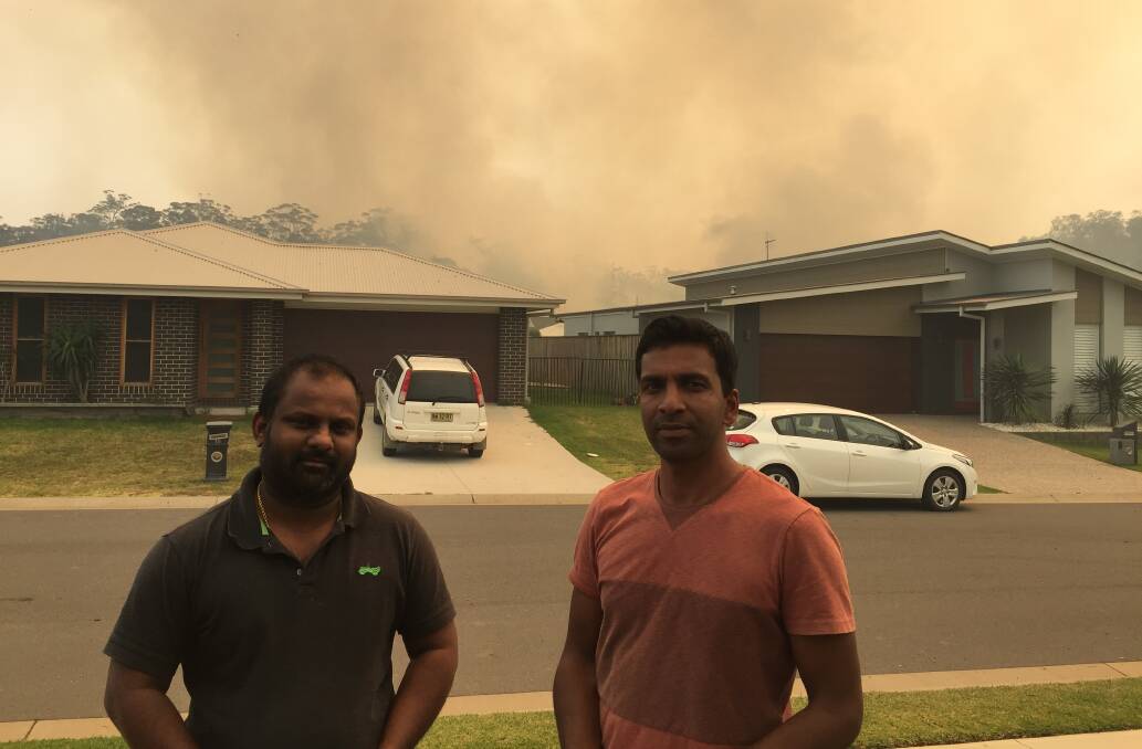 Nurses Vishanth Vasumohan and Mejo Varghese in Masters Street at College Rise near the Seminar Street fire on Friday morning. Photo: Letitia Fitzpatrick.