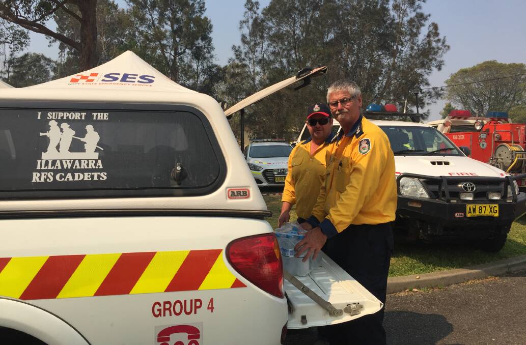 LOADING UP WITH WATER: Captain Andrew Toole and Group Captain Chris Nolan from Illawarra RFS say conditions on Thursday night were grim. Photo: Letitia Fitzpatrick.