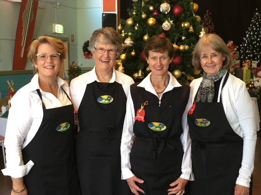 THE FOUR WAITRESSES: Vickie Fisher, Leonie Stevens, Jenny Hurrell and Kerrie Clark bring cheer at Comboyne's Christmas in July.