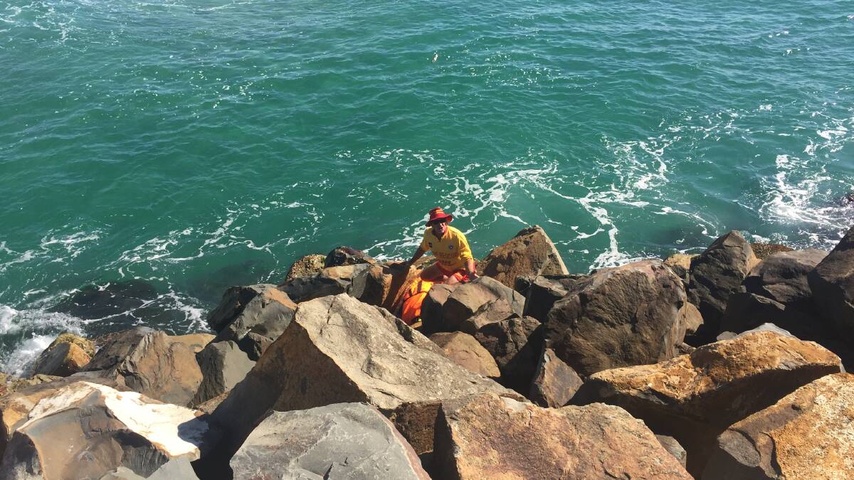 SURF LIFESAVER WAITS FOR MORE HELP FROM OTHER EMERGENCY SERVICES.