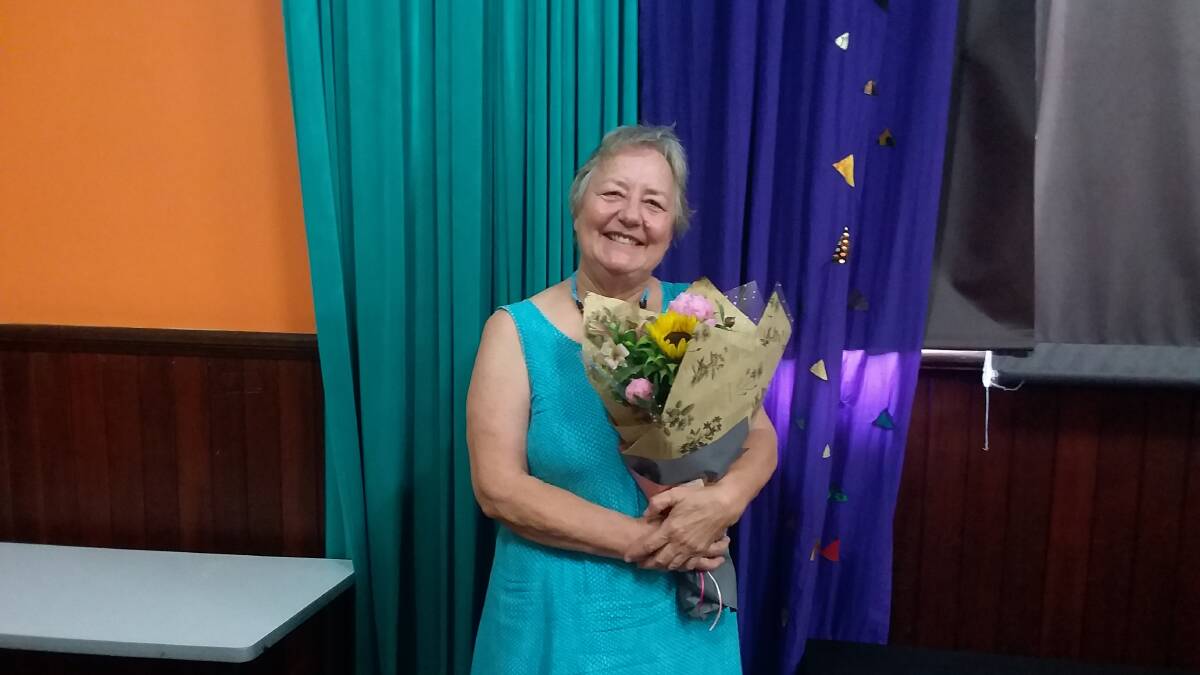MUCH APPRECIATED: Kathryn Parle receives a bouquet of flowers from the Mid North Coast Refugee Support Group of which she has been a very active member.